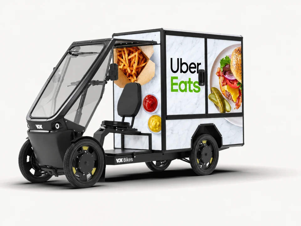 Vok XL with an illustrative Uber Eats black and green advertising wrap and FleetX operator mark
